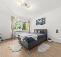A bright bedroom with a bed, a painting, and a wooden decor floor in a family house.