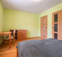 Bedroom in a family house with wooden furniture and a floor with a wooden decor.
