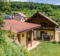 A family house in Horná Lehota with a red roof and surrounding greenery.