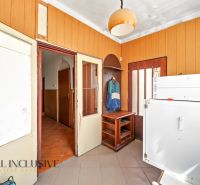 Entrance hallway of a family house with wooden paneling and storage furniture.