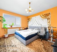 Bedroom with a bed and exercise equipment in a family house.