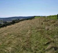 The landscape in Stará Ľubovňa with unique properties offers a view of the pasture and hills.