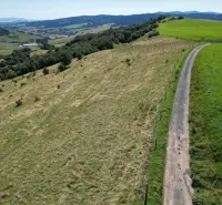 Hilly landscape with green meadows and a country road near the town of Stará Ľubovňa, Unusual properties.