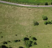 Aerial view of extensive meadows and a road, Unusual properties near Stará Ľubovňa.