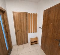 Interior of a 3-room apartment with wood decor doors and tiles.