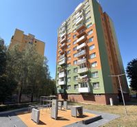 A high-rise residential building with a green-orange facade and a playground in Senica offers a 3-room apartment.