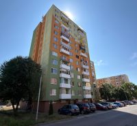 Apartment building with parked cars in Senica, suitable for a 3-room apartment.
