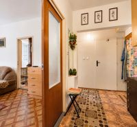 Interior of a 1-room apartment with a wooden decor floor and furniture.