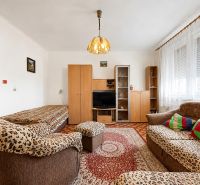 Living room in a studio apartment with sofas and a wooden decor floor.