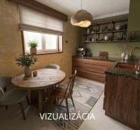 Kitchen in a 2-room apartment with wooden furniture and a round table.