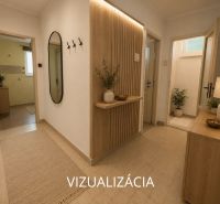 Interior of a 2-room apartment with tiles, flowers, and a large mirror on the wall.