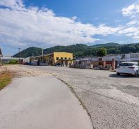 Exterior of the building on Zvolenská Road, Banská Bystrica, with a mountain backdrop and sky.