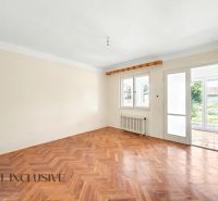 A bright room with a wooden decor floor and a view of the garden in a family house.