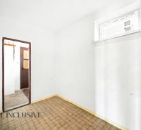 A room in a family house with a tiled floor and white walls.