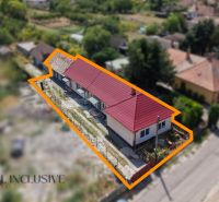 A family house in Vydrany with a red roof, surrounded by a garden and conference spaces.