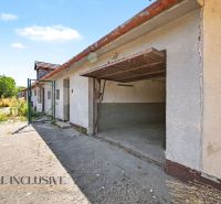 An open garage in the exterior of a family house in Vydrany with a concrete driveway.