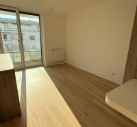 A room in a 3-room apartment with a wooden decor floor and large windows.