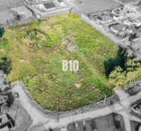 Plots - housing in Nitra with grass cover, surrounded by houses.