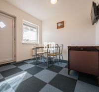 Dining area in a family house with a geometric floor and a crib.