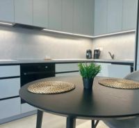 A kitchen in a 2-room apartment with a stylish table and decorations.