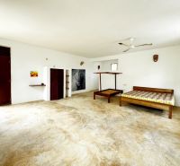 Bedroom in a family house with built-in wardrobes and wall decorations.