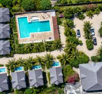 Aerial view of family houses in Pwani Mchangani with a pool and garden.