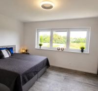Bedroom with a large bed and a view, family house in Trnava.