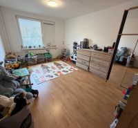 A children's room with toys and a wooden decor floor in a 3-room apartment.