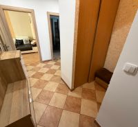 A hallway in a 3-room apartment with tiles and a built-in wardrobe.