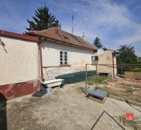 A family house on Stračia Street in Nitra with rustic elements and a satellite dish.