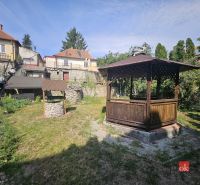 The yard of a family house on Stračia Street in Nitra with a gazebo and a well.