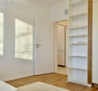 Interior of a 3-room apartment with a shelf and a wooden decor floor.