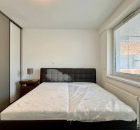 Bedroom in a 3-room apartment with a bed, built-in wardrobe, and nightstand.