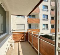 A balcony in a 3-room apartment with a view of the neighboring apartment building.