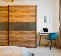 There is a desk, an armchair, and a wardrobe in the 2-room apartment.