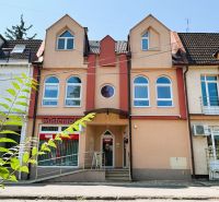 Colorful buildings with shops on Jaroslavská Street in Michalovce, suitable for a 4-room apartment.