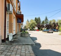 Jaroslawská Street in Michalovce with parked cars and a building for sale.