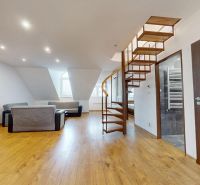Attic living room in a 4-room apartment, floor with wooden decor, spiral staircase.