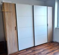The recreational apartment includes a white built-in wardrobe with two wooden doors and a floor with a wooden decor.