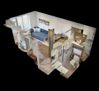 Interior design of a holiday apartment with a wooden decor floor and a compact layout.