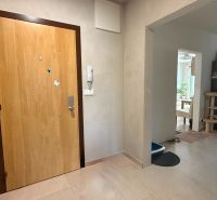 Entrance hall in a 4-room apartment with wood-patterned flooring, open entry to the room.