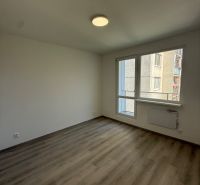 An empty room with a wooden floor and white walls in a 3-room apartment.