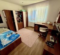 Children's room in a family house with a wardrobe, desk, and floor with wooden decor.