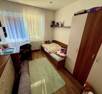 Children's room with wood-decor flooring in a family house. Furniture, bed, desk.