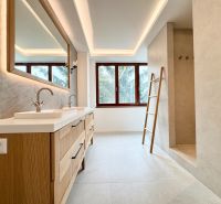 A bathroom in a 3-room apartment with a double sink and a large window.