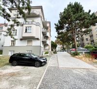 Apartment building near Palisády Street in Bratislava - Old Town, surrounded by greenery and cars.