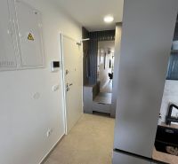 Entrance hallway in a 3-room apartment with minimalist design and tiling.