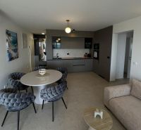 Stylish kitchen and dining room in a 3-room apartment with a large round table.