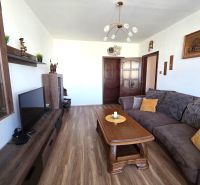 Living room with a comfortable sofa and a wooden decor floor in a 3-room apartment.