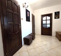 A hallway in a 3-room apartment with brown doors and tiles.